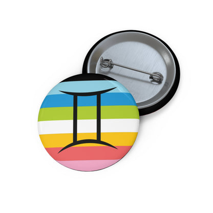 Front and back view of a circular queer pride flag button featuring the Gemini zodiac symbol in black centered on the front.