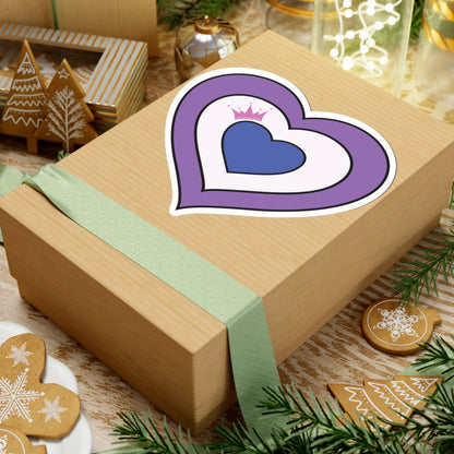 Gift box with a green ribbon on a festive background with cookies and Christmas decorations. Drag pride heart sticker centered on the box.