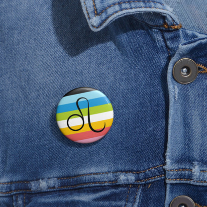 Close-up of a white circular pride button featuring the Leo zodiac glyph centered over a queer pride flag background in pinks, yellow, white, green, blues, and black, attached to a blue denim jacket at the right chest with the button clearly visible.