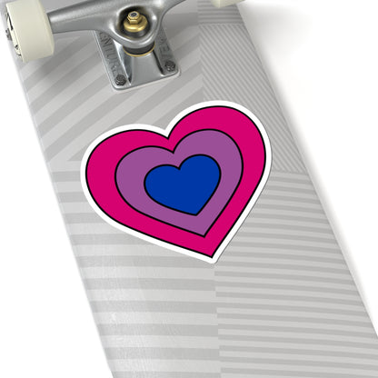 Close-up of the bottom of a silver skateboard featuring a 6 inch by 6 inch pride flag heart sticker in a Bisexual flag style applied to the surface.
