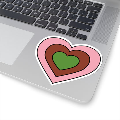 Close-up of the bottom right corner of a silver laptop featuring a 3 inch by 3 inch pride flag heart sticker in a Gynesexual flag style applied to the surface.