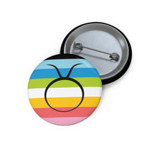 Front and back view of a circular queer pride flag button featuring the Taurus zodiac symbol in black centered on the front.