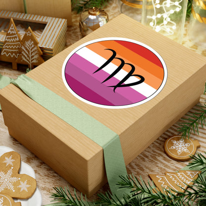 Gift box with a green ribbon on a festive background with cookies and Christmas decorations. Virgo Lesbian pride sticker centered on the box.