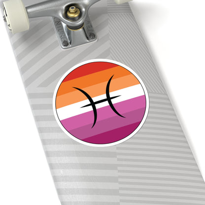 Close-up of the bottom of a silver skateboard featuring a 6 inch by 6 inch circular zodiac sticker with a centered Pisces glyph on a Lesbian pride flag style background applied to the surface.