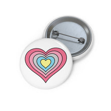 Front and back view of a white circular button with a heart-shaped genderflux flag image. The button is shown on a white background.