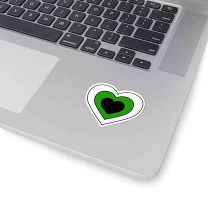 Close-up of the bottom right corner of a silver laptop featuring a 2 inch by 2 inch pride flag heart sticker in a Neutrois flag style applied to the surface.