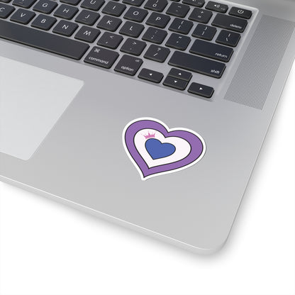 Close-up of the bottom right corner of a silver laptop featuring a 2 inches by 2 inches pride flag heart sticker in a Drag pride flag style applied to the surface.