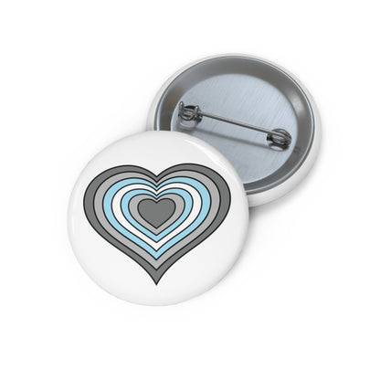 Front and back view of a white circular button with a heart-shaped demiboy flag image. The button is shown on a white background.