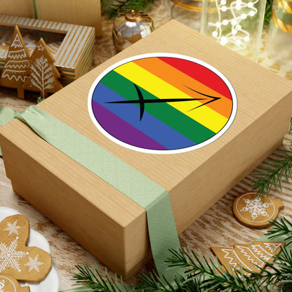 Gift box with a green ribbon on a festive background with cookies and Christmas decorations. Sagittarius Rainbow pride sticker centered on the box.
