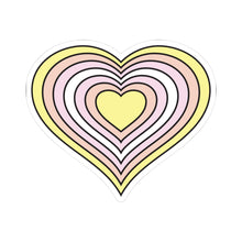 Heart-shaped pangender pride flag sticker featuring nested heart stripes in yellow, light orange, pink, white, pink, light orange, and yellow, outlined with a thin black border and a white sticker border. The sticker is shown on a white background.