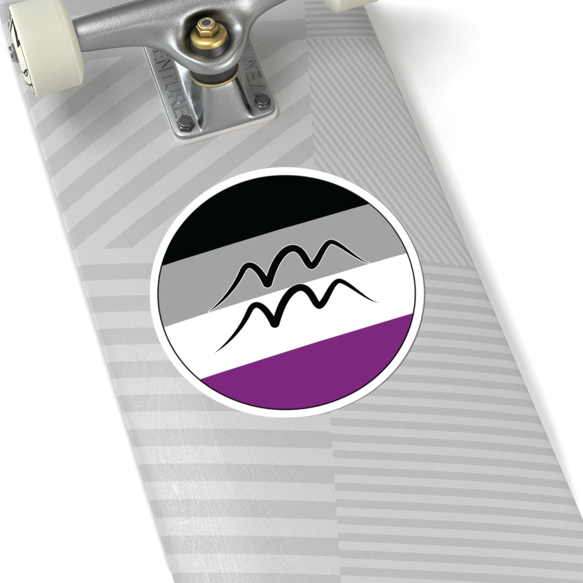 Close-up of the bottom of a silver skateboard featuring a 6 inch by 6 inch circular zodiac sticker with a centered Aquarius glyph on an Asexual pride flag style background applied to the surface.