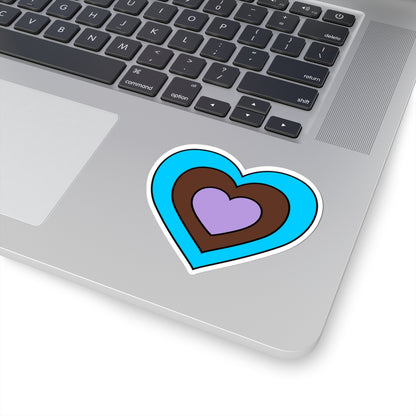 Close-up of the bottom right corner of a silver laptop featuring a 3 inch by 3 inch pride flag heart sticker in an Androsexual flag style applied to the surface.