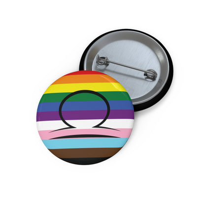 Front and back view of a circular progress pride flag button featuring the Libra zodiac symbol in black centered on the front.