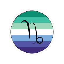 Circular gay men pride flag zodiac sticker with a thin black outline and white sticker border, featuring a centered black Capricorn zodiac glyph. The sticker is shown on a white background.