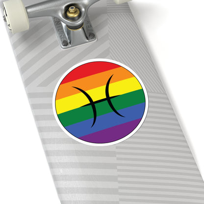 Close-up of the bottom of a silver skateboard featuring a 6 inch by 6 inch circular zodiac sticker with a centered Pisces glyph on a Rainbow pride flag style background applied to the surface.