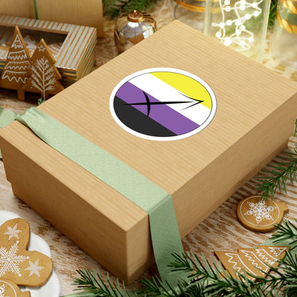 Gift box with a green ribbon on a festive background with cookies and Christmas decorations. Sagittarius Nonbinary pride sticker centered on the box.