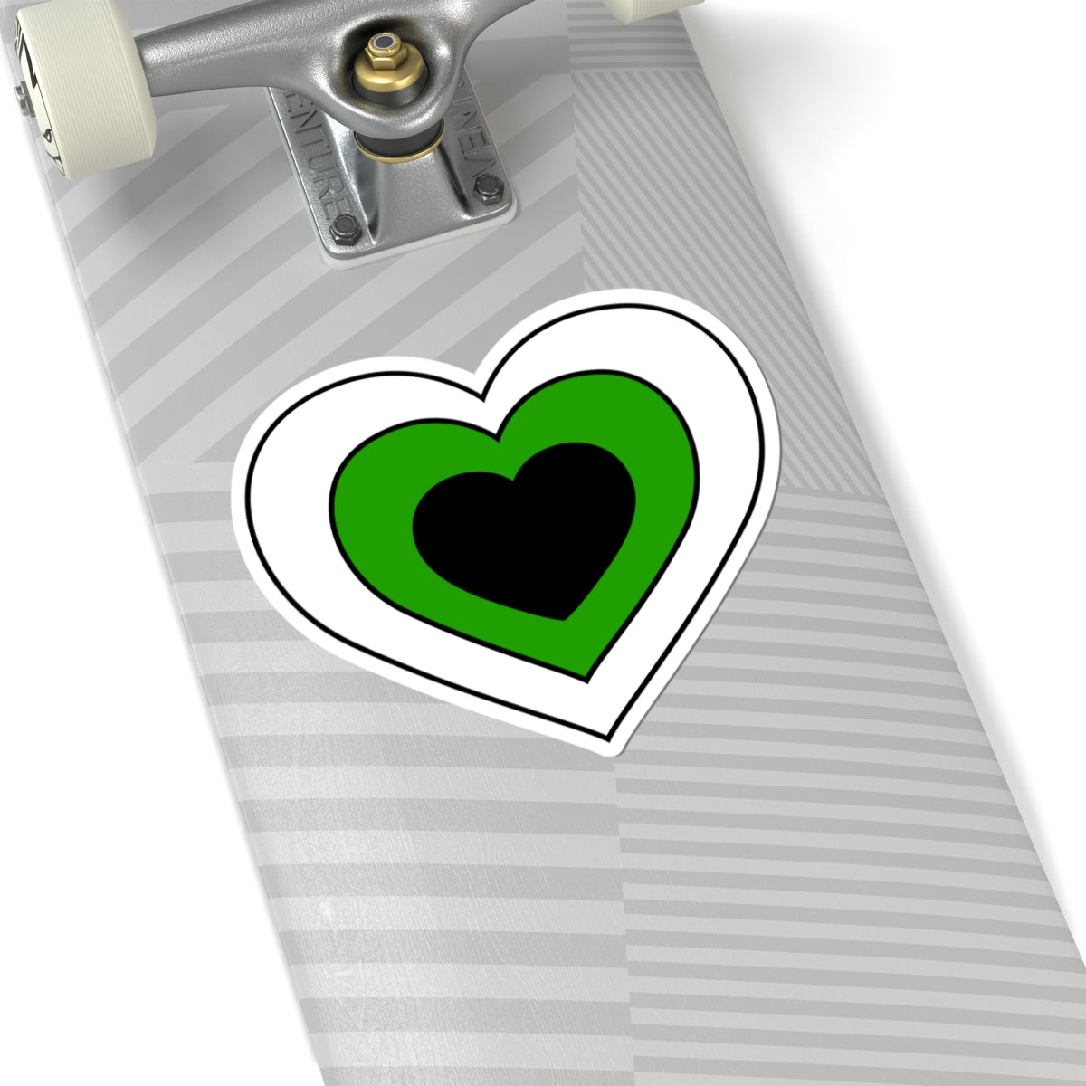 Close-up of the bottom of a silver skateboard featuring a 6 inch by 6 inch pride flag heart sticker in a Neutrois flag style applied to the surface.