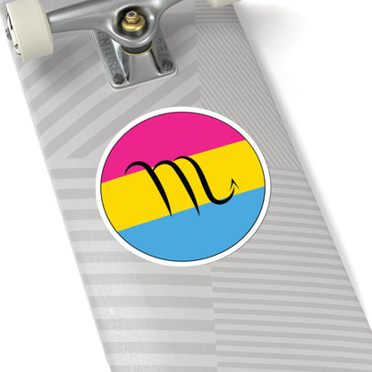 Close-up of the bottom of a silver skateboard featuring a 6 inch by 6 inch circular zodiac sticker with a centered Scorpio glyph on a Pansexual pride flag style background applied to the surface.