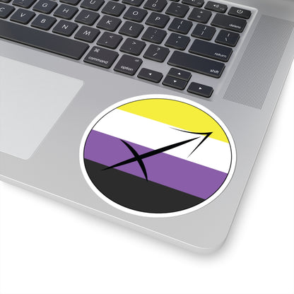 Close-up of the bottom right corner of a silver laptop featuring a 4 inch by 4 inch circular zodiac sticker with a centered Sagittarius glyph on an Nonbinary pride flag style background applied to the surface.