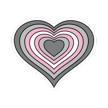 Heart-shaped demigirl pride flag sticker featuring nested heart stripes in dark gray, light gray, pink, and white outlined with a thin black border and a white sticker border. The sticker is shown on a white background.