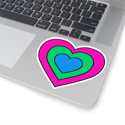 Close-up of the bottom right corner of a silver laptop featuring a 4 inch by 4 inch pride flag heart sticker in a Polysexual flag style applied to the surface.