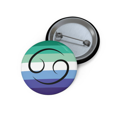 Front and back view of a circular gay men pride flag button featuring the Cancer zodiac symbol in black centered on the front.
