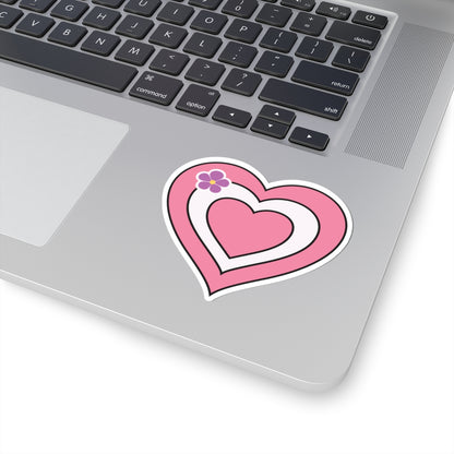 Close-up of the bottom right corner of a silver laptop featuring a 3 inch by 3 inch pride flag heart sticker in a Sapphic pride flag style applied to the surface.