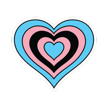 Heart-shaped black transgender pride flag sticker featuring nested heart stripes in light blue, pink, black, pink, light blue, outlined with a thin black border and a white sticker border. The sticker is shown on a white background.