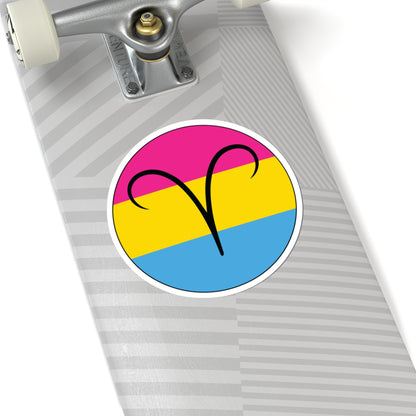 Close-up of the bottom of a silver skateboard featuring a 6 inch by 6 inch circular zodiac sticker with a centered Aires glyph on a Pansexual pride flag style background applied to the surface.