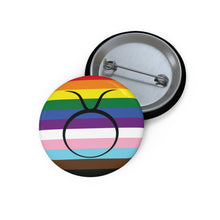 Front and back view of a circular progress pride flag button featuring the Taurus zodiac symbol in black centered on the front.