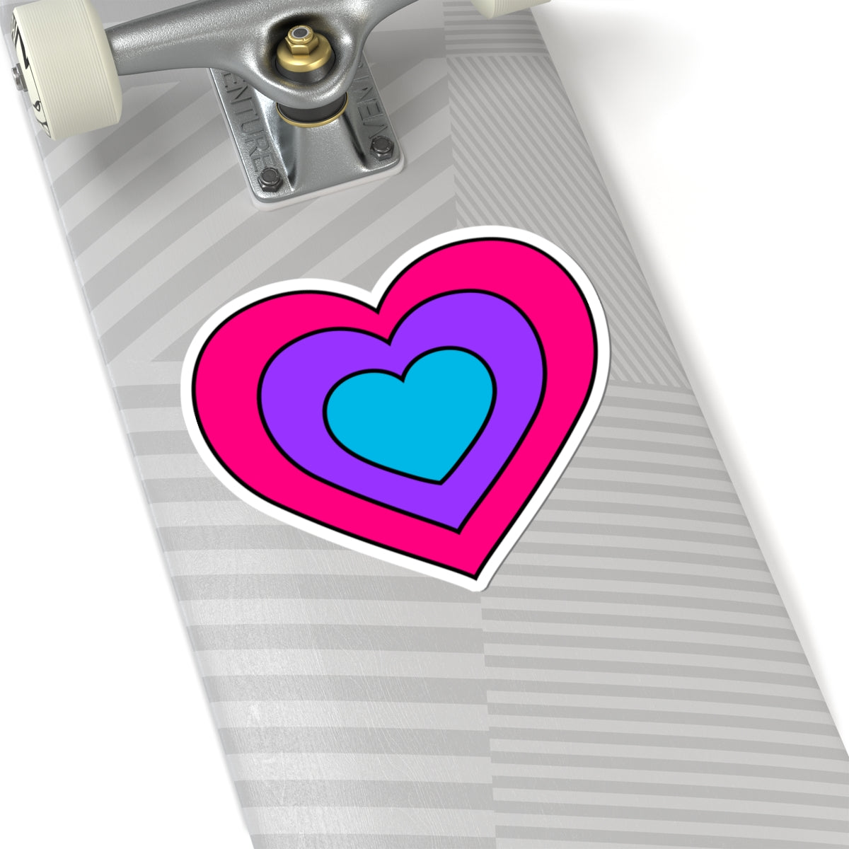 Close-up of the bottom of a silver skateboard featuring a 6 inch by 6 inch pride flag heart sticker in an Androgyne flag style applied to the surface.