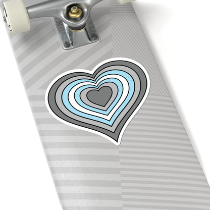 Close-up of the bottom of a silver skateboard featuring a 6 inch by 6 inch pride flag heart sticker in a Demiboy flag style applied to the surface.