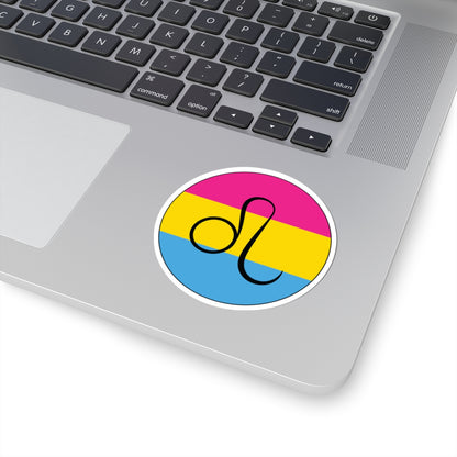 Close-up of the bottom right corner of a silver laptop featuring a 3 inch by 3 inch circular zodiac sticker with a centered Leo glyph on a Pansexual pride flag style background applied to the surface.