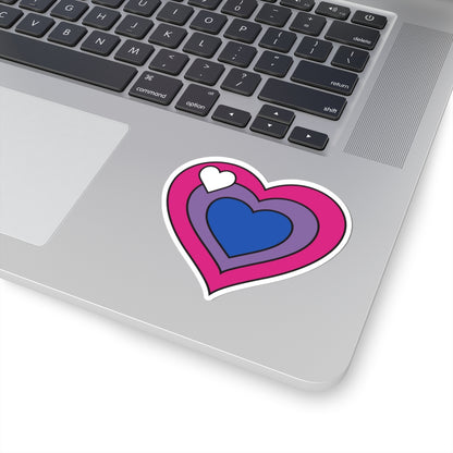 Close-up of the bottom right corner of a silver laptop featuring a 3 inch by 3 inch pride flag heart sticker in a Biromantic flag style applied to the surface.