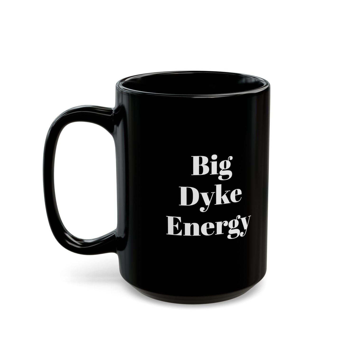 A black mug with the words "Big Dyke Energy" printed in white letters on the side facing outward if the mug is held by the handle in the right hand. The image of the mug is shown on a white background.