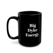 A black mug with the words "Big Dyke Energy" printed in white letters on the side facing outward if the mug is held by the handle in the right hand. The image of the mug is shown on a white background.