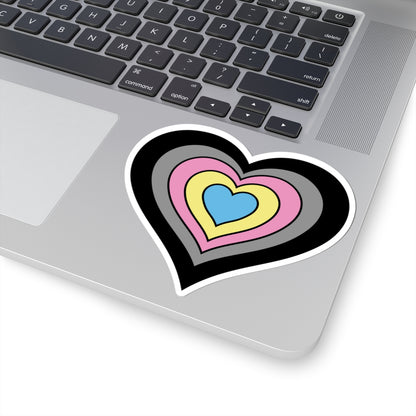 Close-up of the bottom right corner of a silver laptop featuring a 4 inch by 4 inch pride flag heart sticker in a Polygender flag style applied to the surface.
