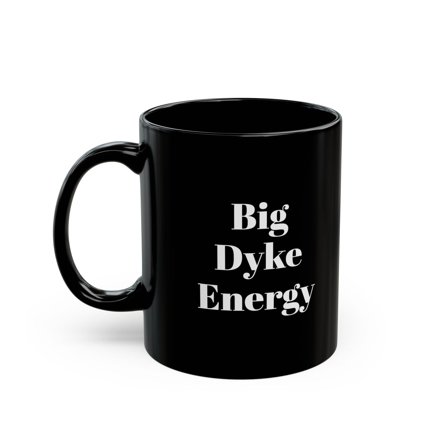 A black mug with the words "Big Dyke Energy" printed in white letters on the side facing outward if the mug is held by the handle in the right hand. The image of the mug is shown on a white background.