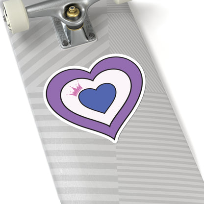 Close-up of the bottom of a silver skateboard featuring a 6 inch by 6 inch pride flag heart sticker in a Drag pride flag style applied to the surface.