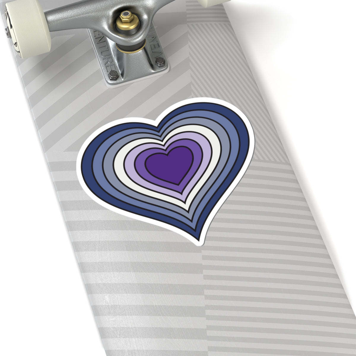 Close-up of the bottom of a silver skateboard featuring a 6 inch by 6 inch pride flag heart sticker in a Purple Butch pride flag style applied to the surface.