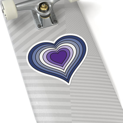 Close-up of the bottom of a silver skateboard featuring a 6 inch by 6 inch pride flag heart sticker in a Purple Butch pride flag style applied to the surface.