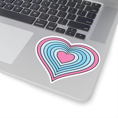 Close-up of the bottom right corner of a silver laptop featuring a 4 inch by 4 inch pride flag heart sticker in a Transmasc flag style applied to the surface.