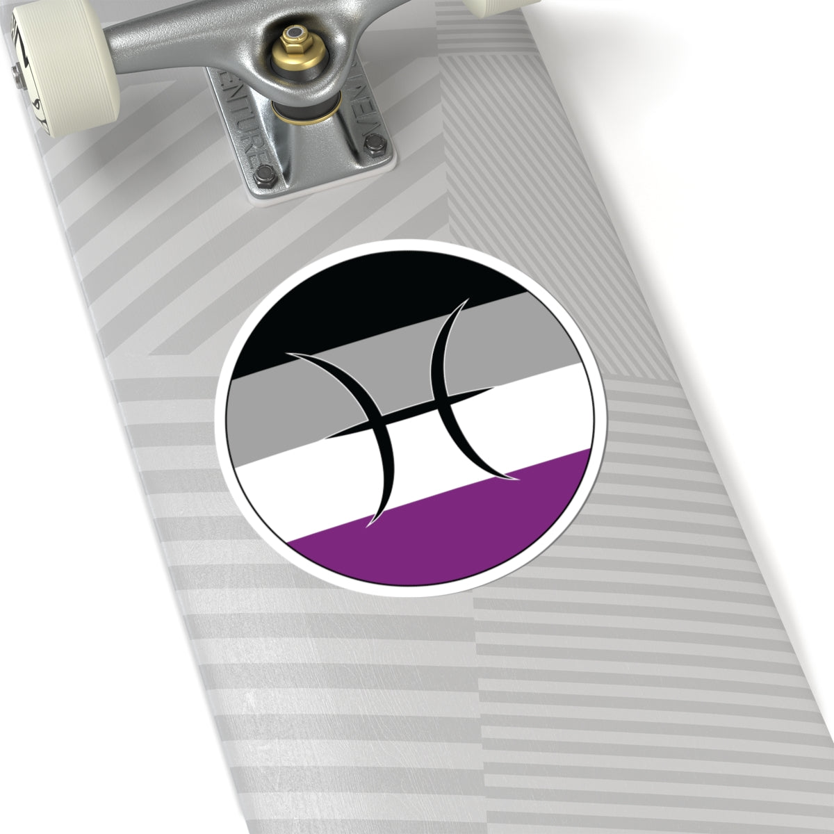 Close-up of the bottom of a silver skateboard featuring a 6 inch by 6 inch circular zodiac sticker with a centered Pisces glyph on an Asexual pride flag style background applied to the surface.