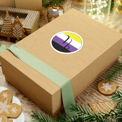 Gift box with a green ribbon on a festive background with cookies and Christmas decorations. Capricorn Nonbinary pride sticker centered on the box.