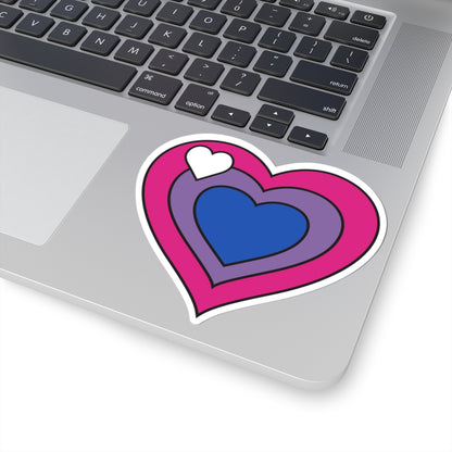 Close-up of the bottom right corner of a silver laptop featuring a 4 inch by 4 inch pride flag heart sticker in a Biromantic flag style applied to the surface.