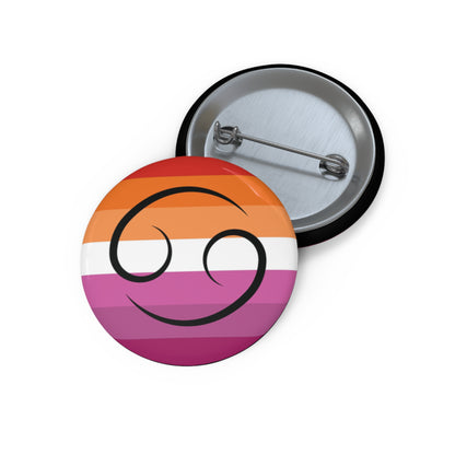 Front and back view of a circular lesbian pride flag button featuring the Cancer zodiac symbol in black centered on the front.