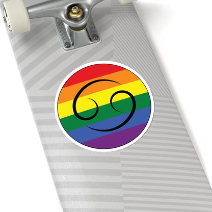 Close-up of the bottom of a silver skateboard featuring a 6 inch by 6 inch circular zodiac sticker with a centered Cancer glyph on a Rainbow pride flag style background applied to the surface.