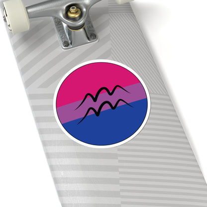 Close-up of the bottom of a silver skateboard featuring a 6 inch by 6 inch circular zodiac sticker with a centered Aquarius glyph on a Bisexual pride flag style background applied to the surface.
