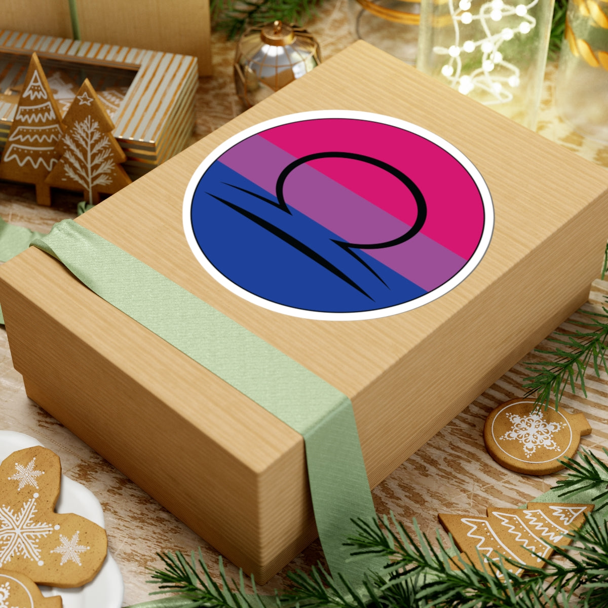 Gift box with a green ribbon on a festive background with cookies and Christmas decorations. Libra Bisexual pride sticker centered on the box.