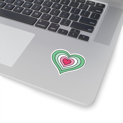 Close-up of the bottom right corner of a silver laptop featuring a 2 inch by 2 inch pride flag heart sticker in an Abrosexual flag style applied to the surface.